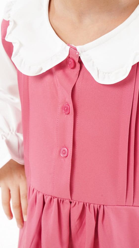 مريول ابتدائي بلون وردي وقميص مشبوك